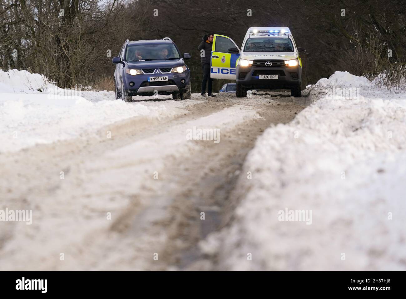 A motorist speaks to Police along the snow-covered A515 near Biggin, in the Peak District, Derbyshire, amid freezing conditions in the aftermath of Storm Arwen. Picture date: Sunday November 28, 2021. Stock Photo