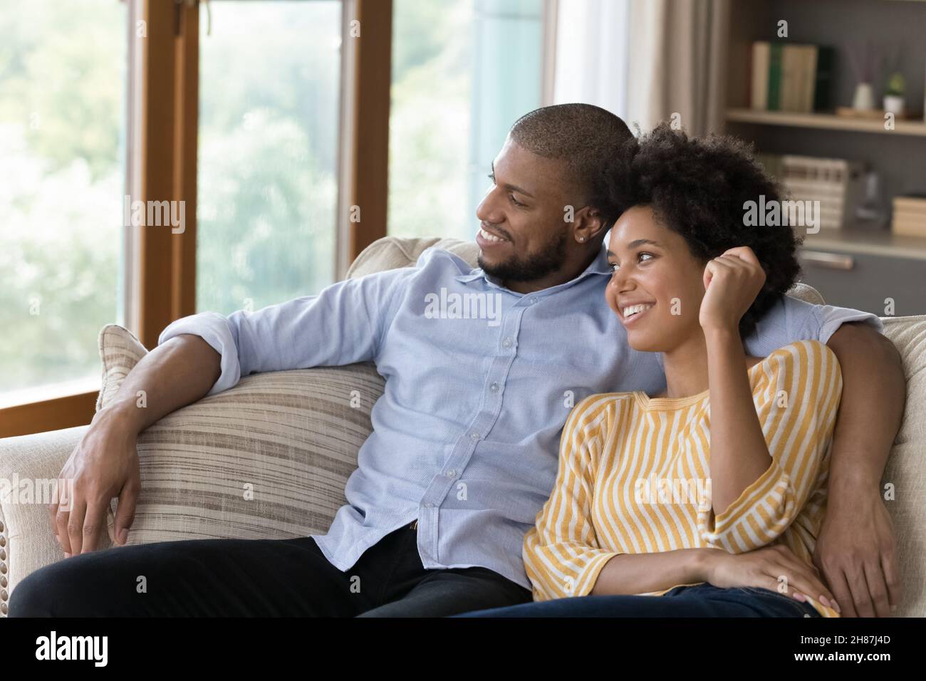 Black couple relaxing on sofa hi-res stock photography and images - Alamy