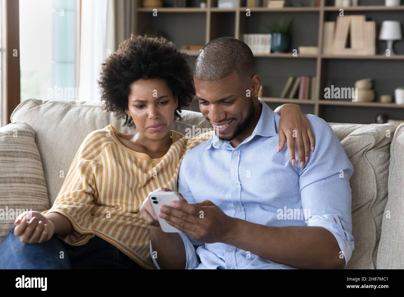 Couple using online app on cellphone, chatting on internet Stock Photo