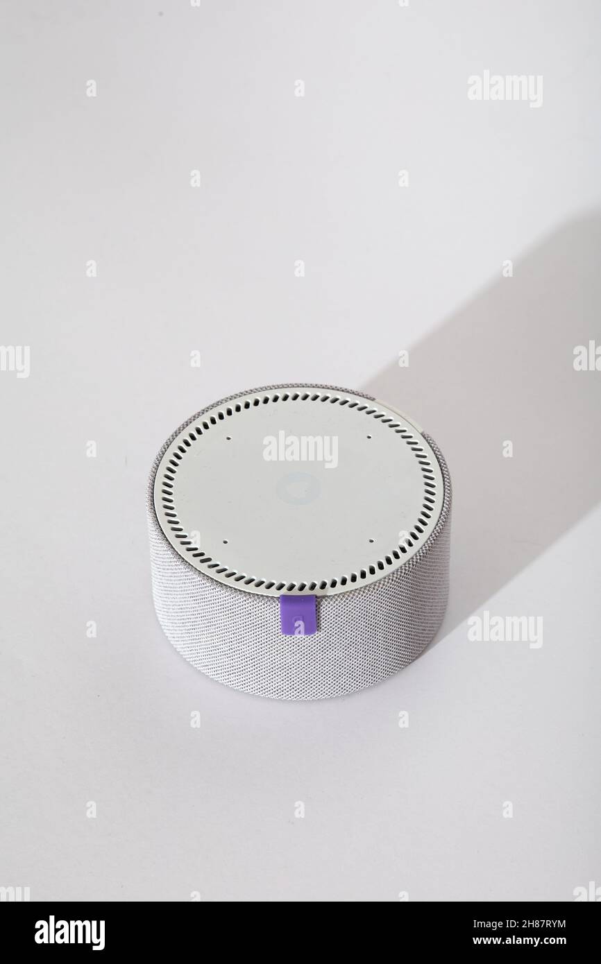 Smart speaker Yandex mini on white table.  Stock Photo