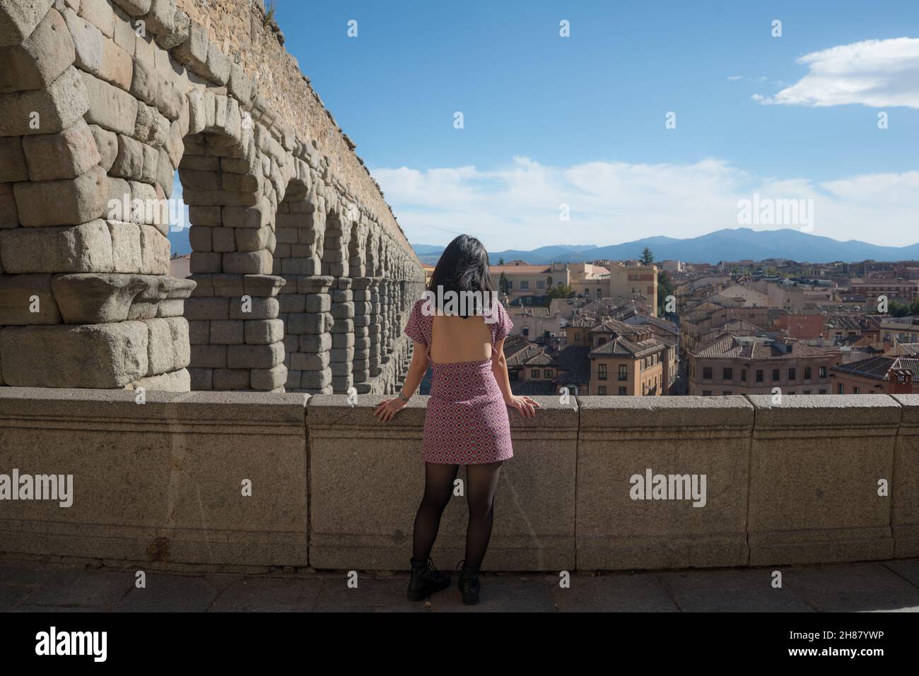 woman at Segovia acueducto viewpoint during vacation in Spain - young happy woman visiting world heritage aqueduct in Segovia enjoying holidays travel Stock Photo