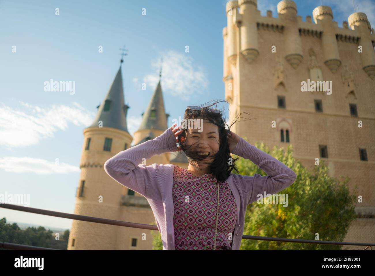 Young Asian woman outdoors lifestyle portrait -  happy and beautiful Chinese girl enjoying  fairytale style castle from viewpoint during holiday trave Stock Photo