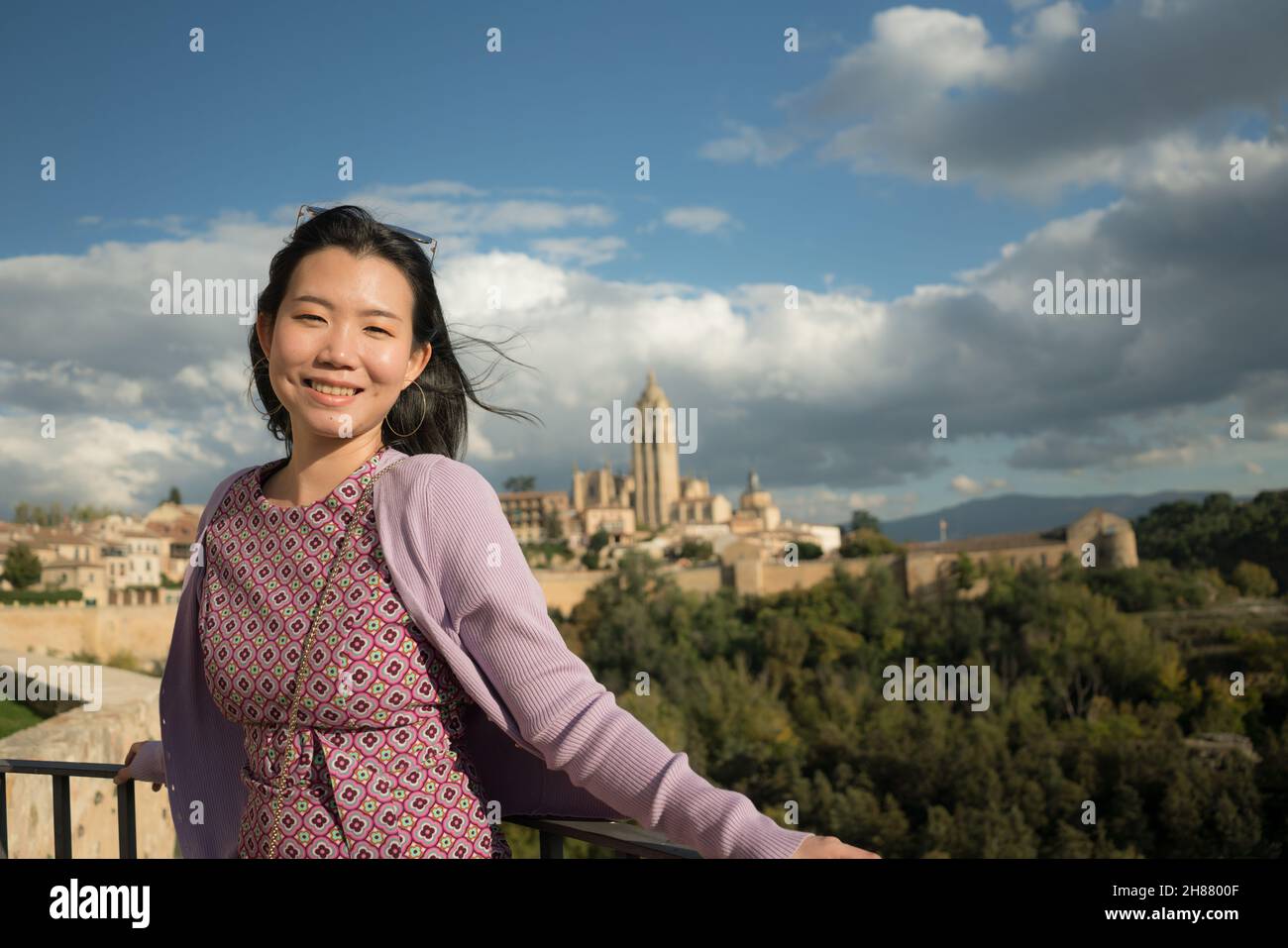 Young Asian woman outdoors lifestyle portrait -  happy and beautiful Chinese girl enjoying old town panorama from viewpoint during holiday travel in E Stock Photo
