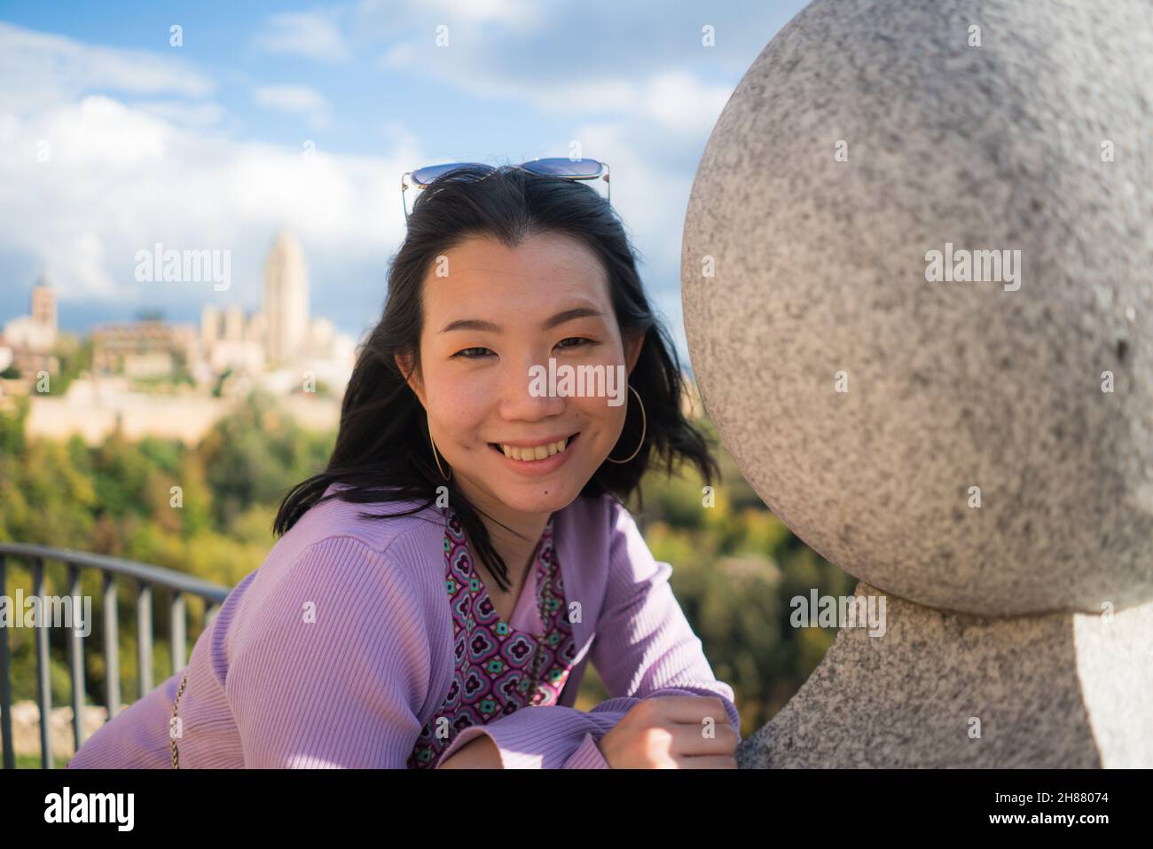 Young Asian woman outdoors lifestyle portrait -  happy and beautiful Korean girl enjoying old town panorama from viewpoint during holiday travel in Eu Stock Photo