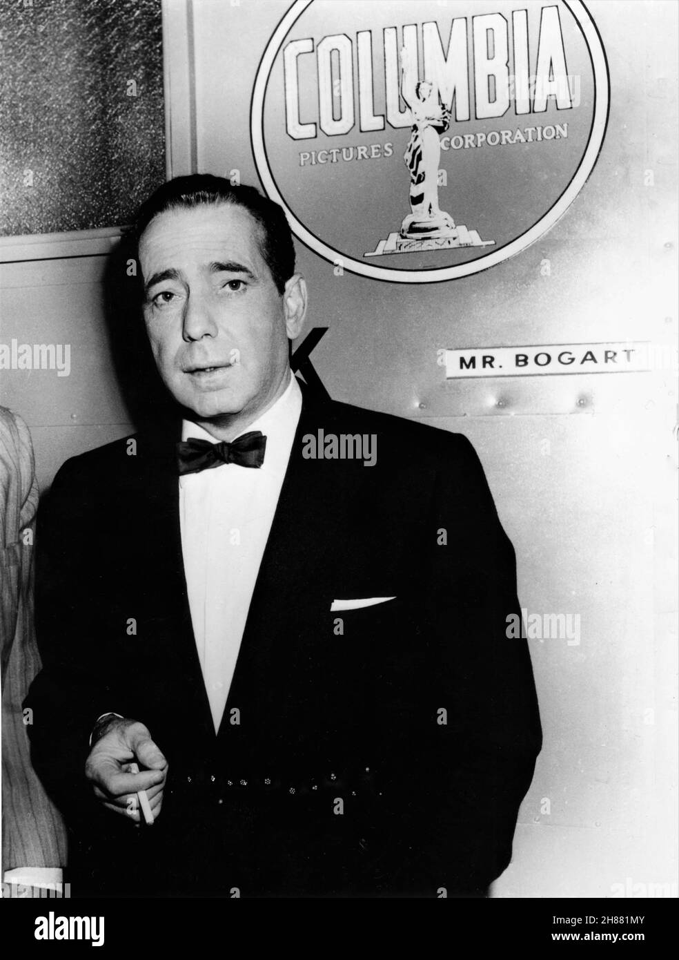 HUMPHREY BOGART on set candid outside his dressing room during filming of THE HARDER THEY FALL 1956 director MARK ROBSON novel Budd Schulberg Columbia Pictures Stock Photo