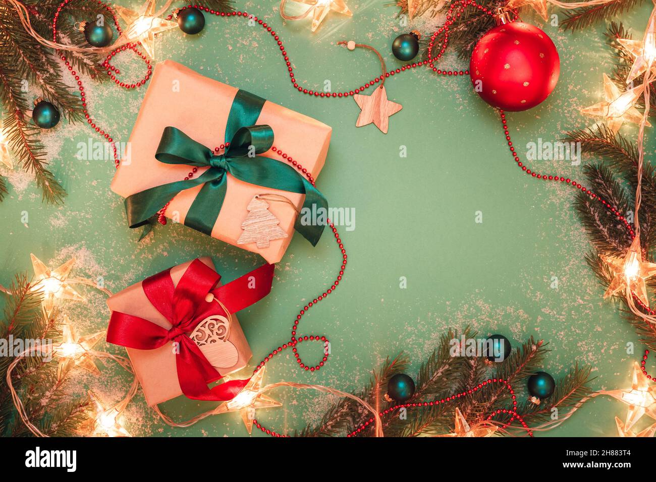 Christmas present boxes on green background with decorations Stock