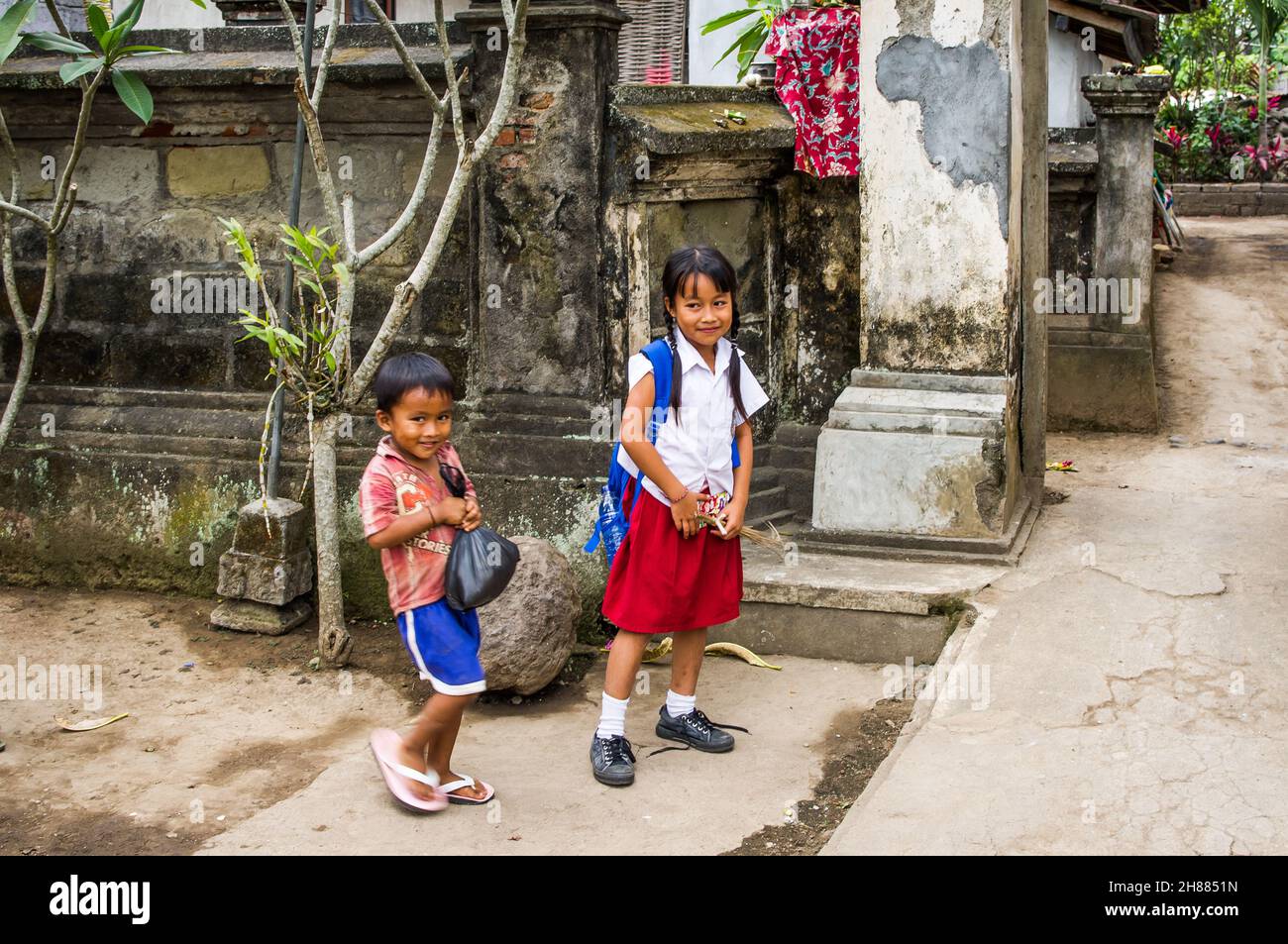 indonesian students boy and girl coming home from school. Stock Photo