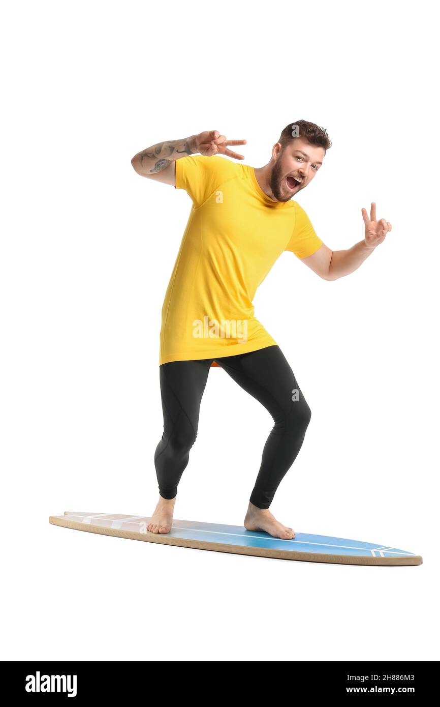 Handsome bearded man with surfboard showing victory gesture on white background Stock Photo