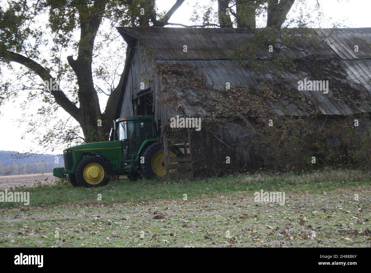 John Deere tractor in an Old Missouri Barn Stock Photo Alamy