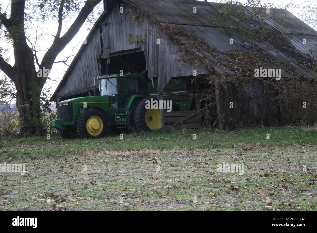 John Deere tractor in an Old Missouri Barn Stock Photo Alamy