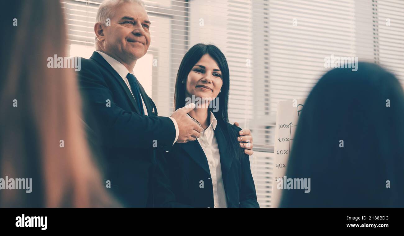 boss introducing a young employee during a meeting Stock Photo - Alamy