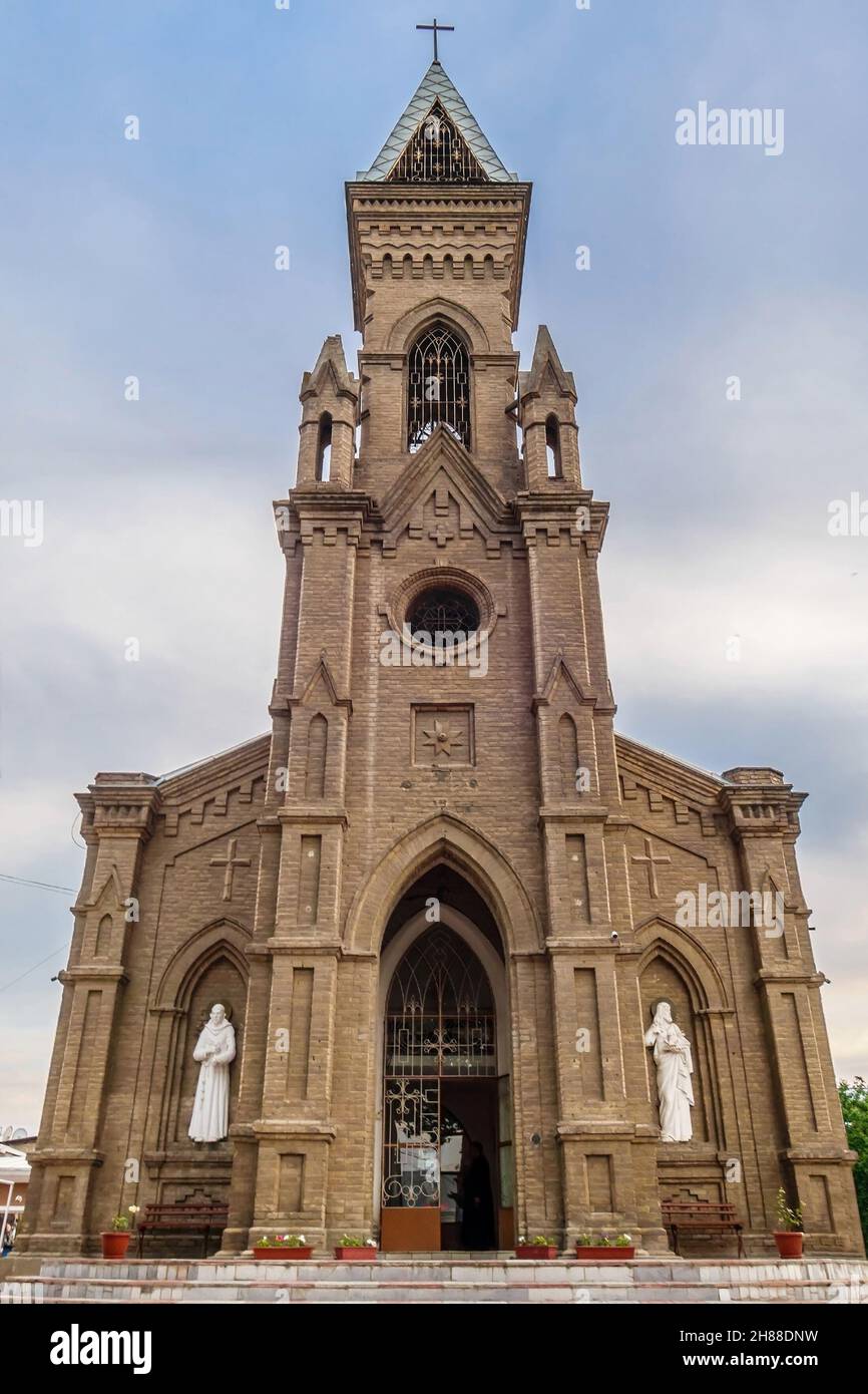 Main facade of Catholic Church of St. John the Baptist, Samarkand, Uzbekistan. Building was built in 1915 by prisoners of war from Europe (Poles, Aust Stock Photo