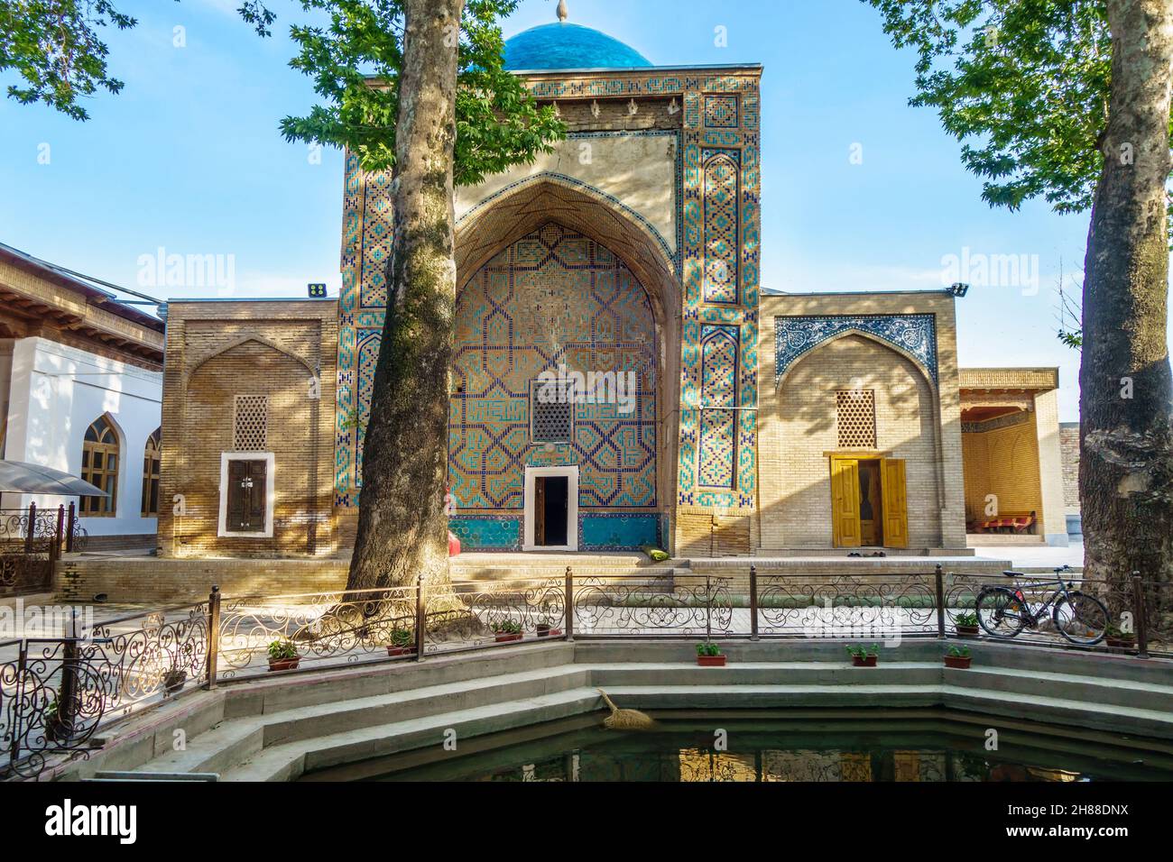 Facade of mausoleum of Khoja Abdi Darun in Samarkand, Uzbekistan. Traditional howz is visible ahead. Building was founded in XII Stock Photo