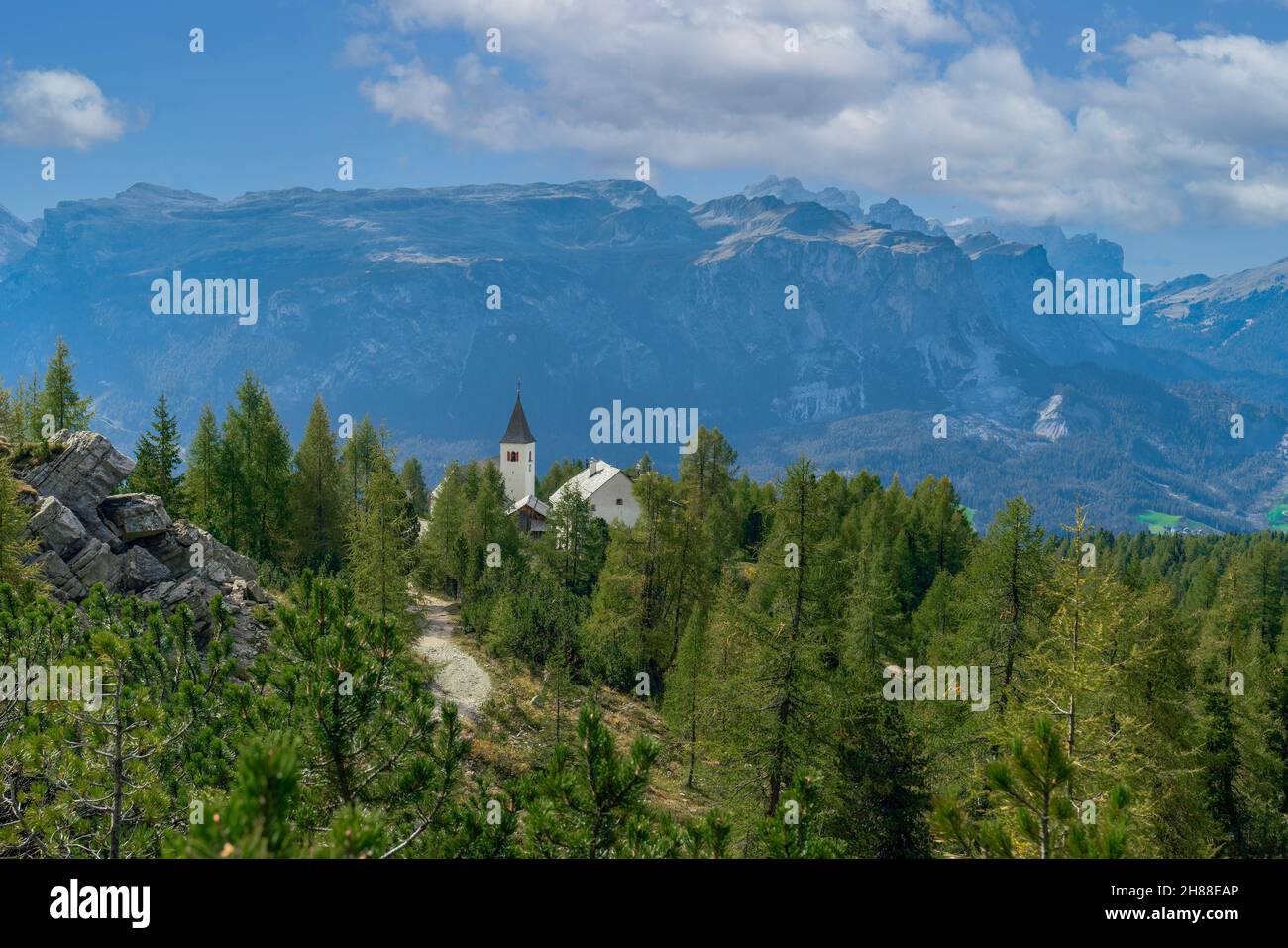 The Santa Croce Sanctuary in Alta Badia overlooking the mountains of Fanes – Senes – Braies Nature Park in the italian Dolomites Stock Photo