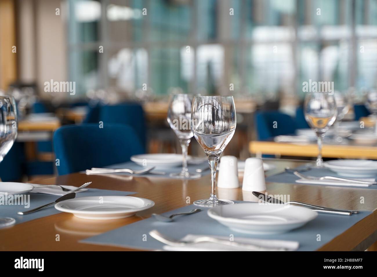 Empty Plates and Glasses in Luxury Restaurant with Blurred Background