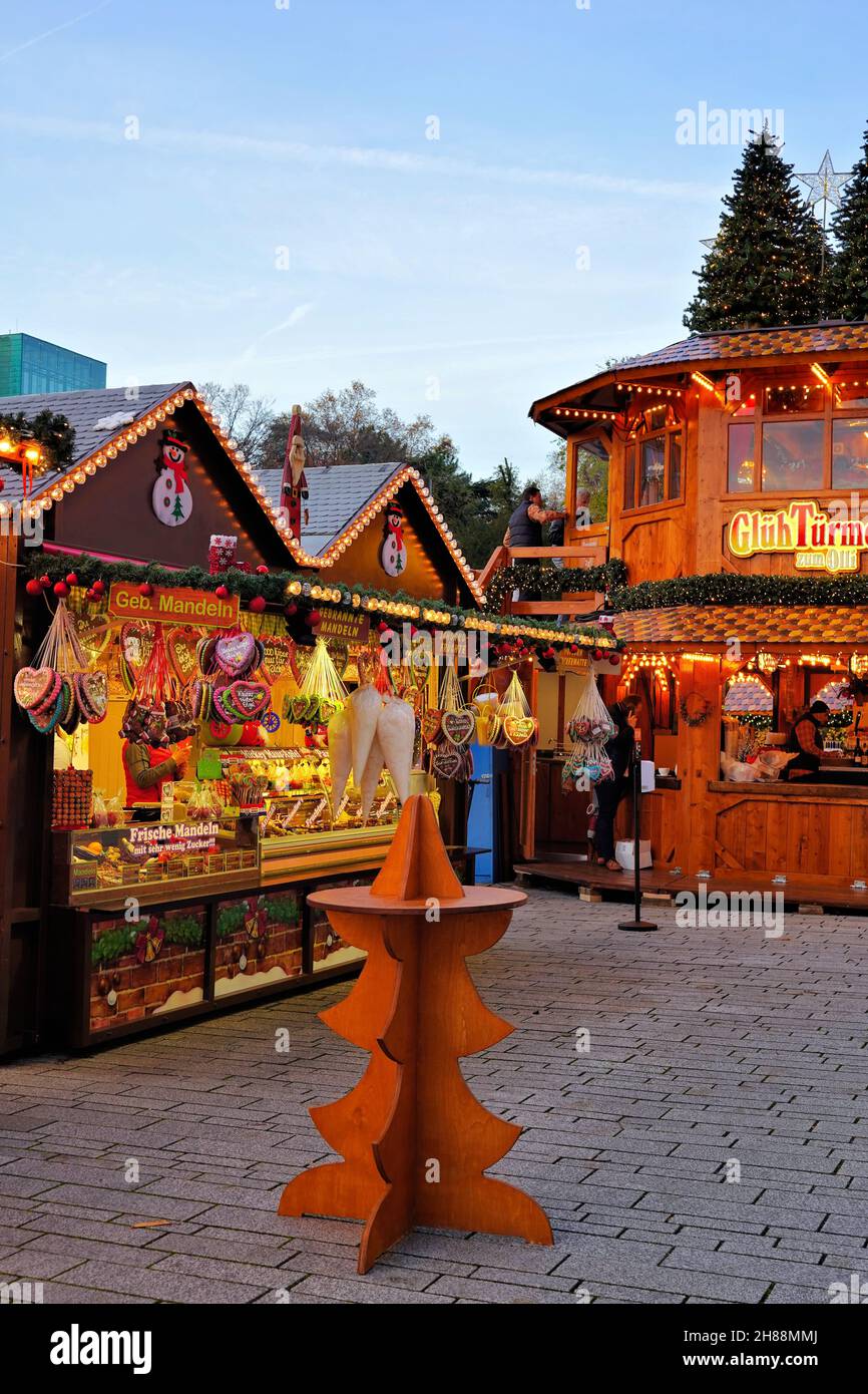 Candy stand and mulled wine stand at the Christmas market 2021 on Schadowplatz in downtown Düsseldorf/Germany. Stock Photo