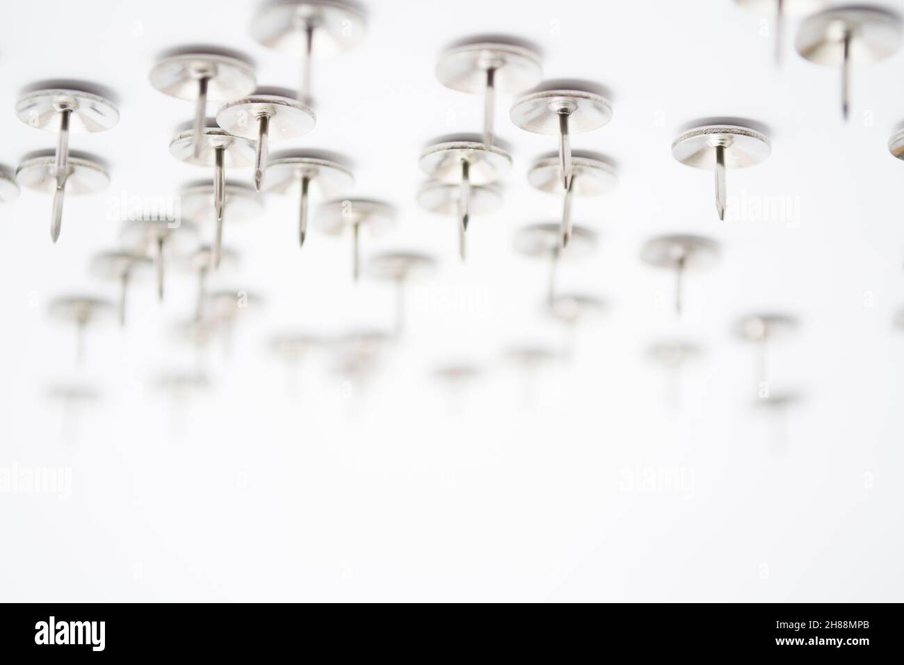 Heap of Metal Pushpin or Drawing Pin isolated on white Stock Photo