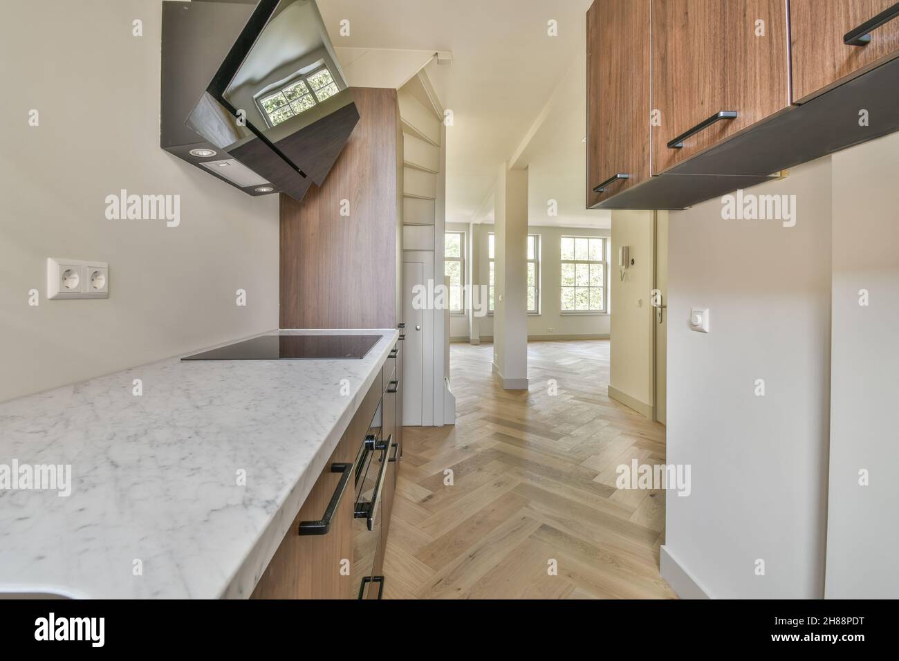 White marble kitchen countertop with modern range hood Stock Photo Alamy