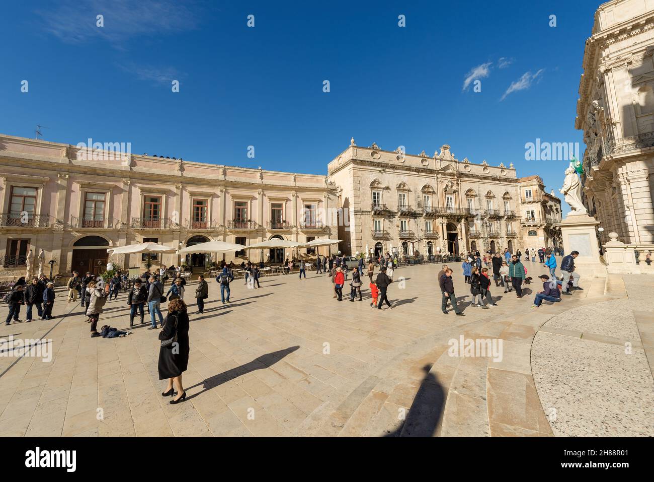 Tourists visit the Cathedral Square (Piazza del Duomo) in the island of Ortigia, historic center of Siracusa, Sicily island, Italy, Europe. Stock Photo