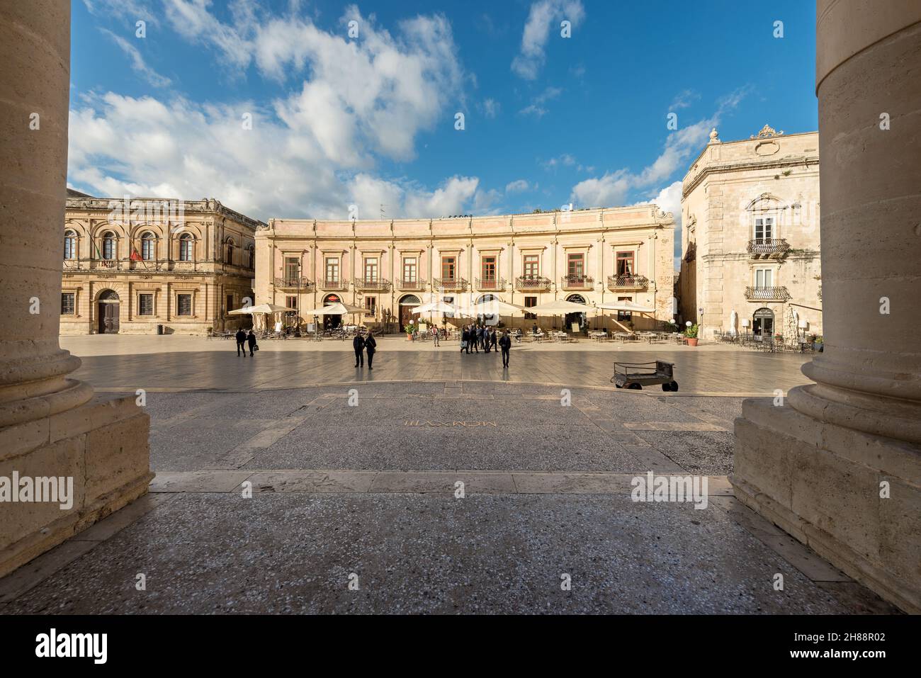 Tourists visit the Cathedral Square (Piazza del Duomo) in the island of Ortigia, historic center of Siracusa, Sicily island, Italy, Europe. Stock Photo