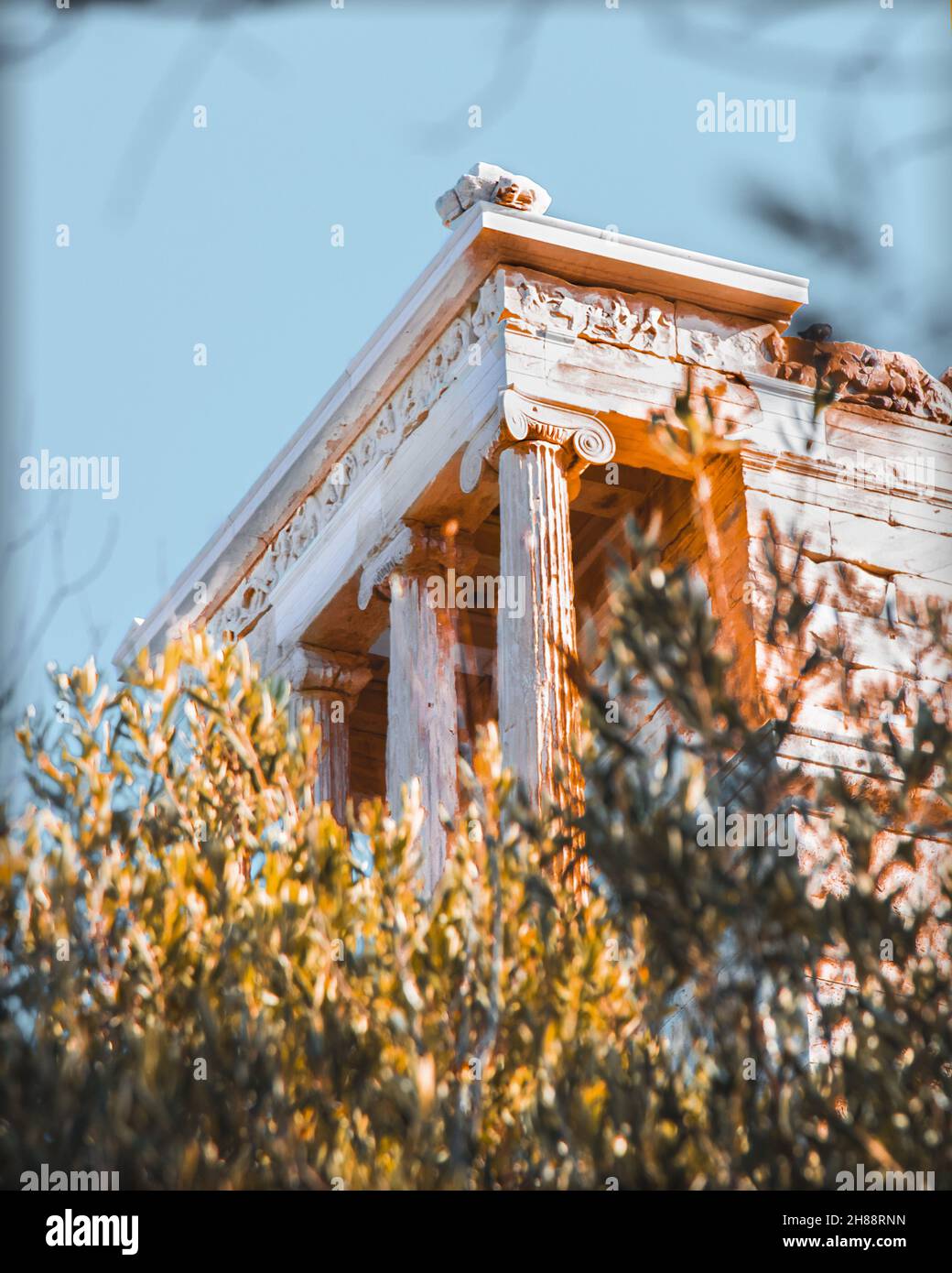 A beautiful golden sunrise at the Acropolis of Athens, shining on the Partheon, located atop of Acropolis hill in the centre of Athens old town. Stock Photo