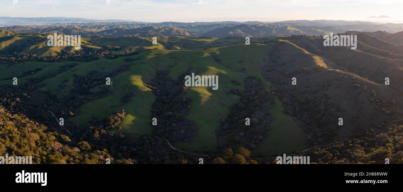 Early morning light shines on the rolling hills in the East Bay region near San Francisco Bay, California. This area turns green during winter months. Stock Photo