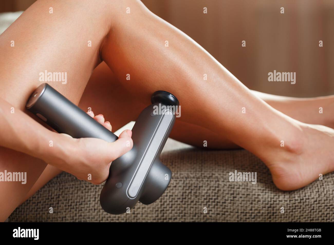 Massage of women's legs with a shock massage device. Shock self-massage to  restore fascia muscles and trigger points Stock Photo - Alamy