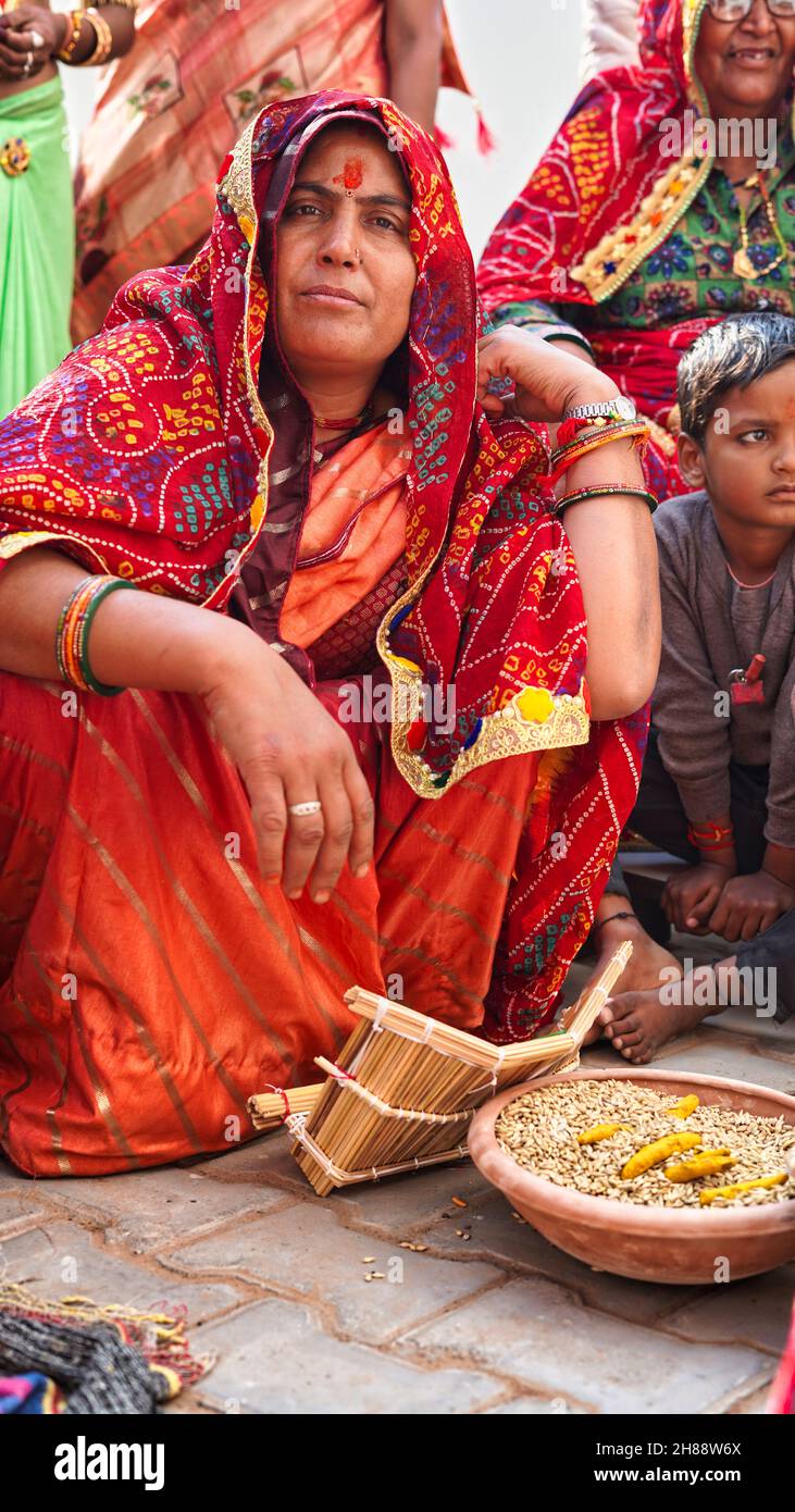 21 November 2021 Reengus, Rajasthan, India. Indian wedding season photography. Unidentified Indian woman looking at the camera at the groom's house. Stock Photo