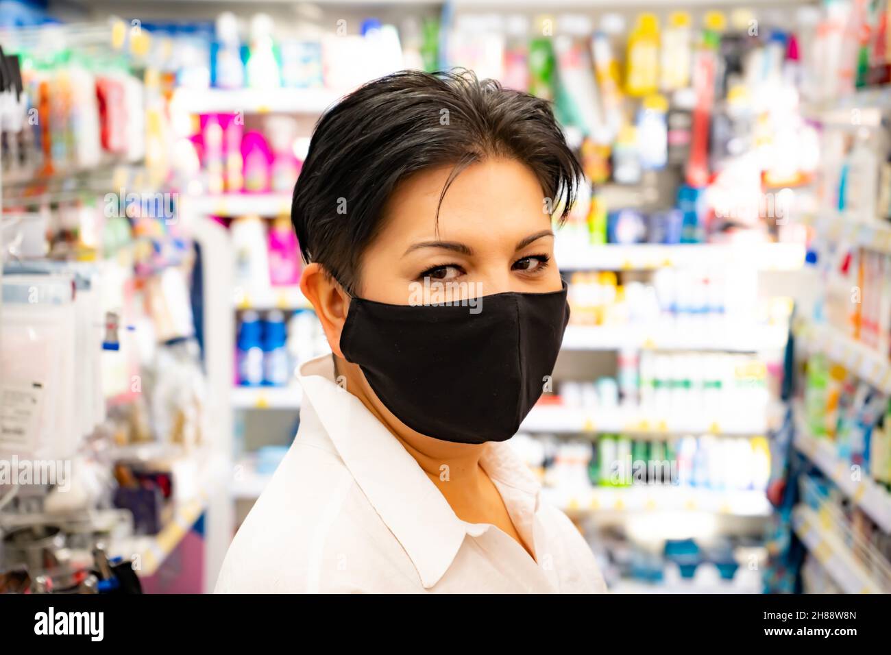 Happy natural asian woman in supermarket. Looking camera Stock Photo