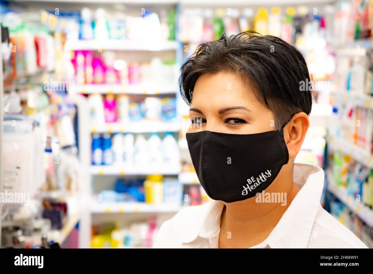 Happy natural asian woman in supermarket. Looking camera Stock Photo