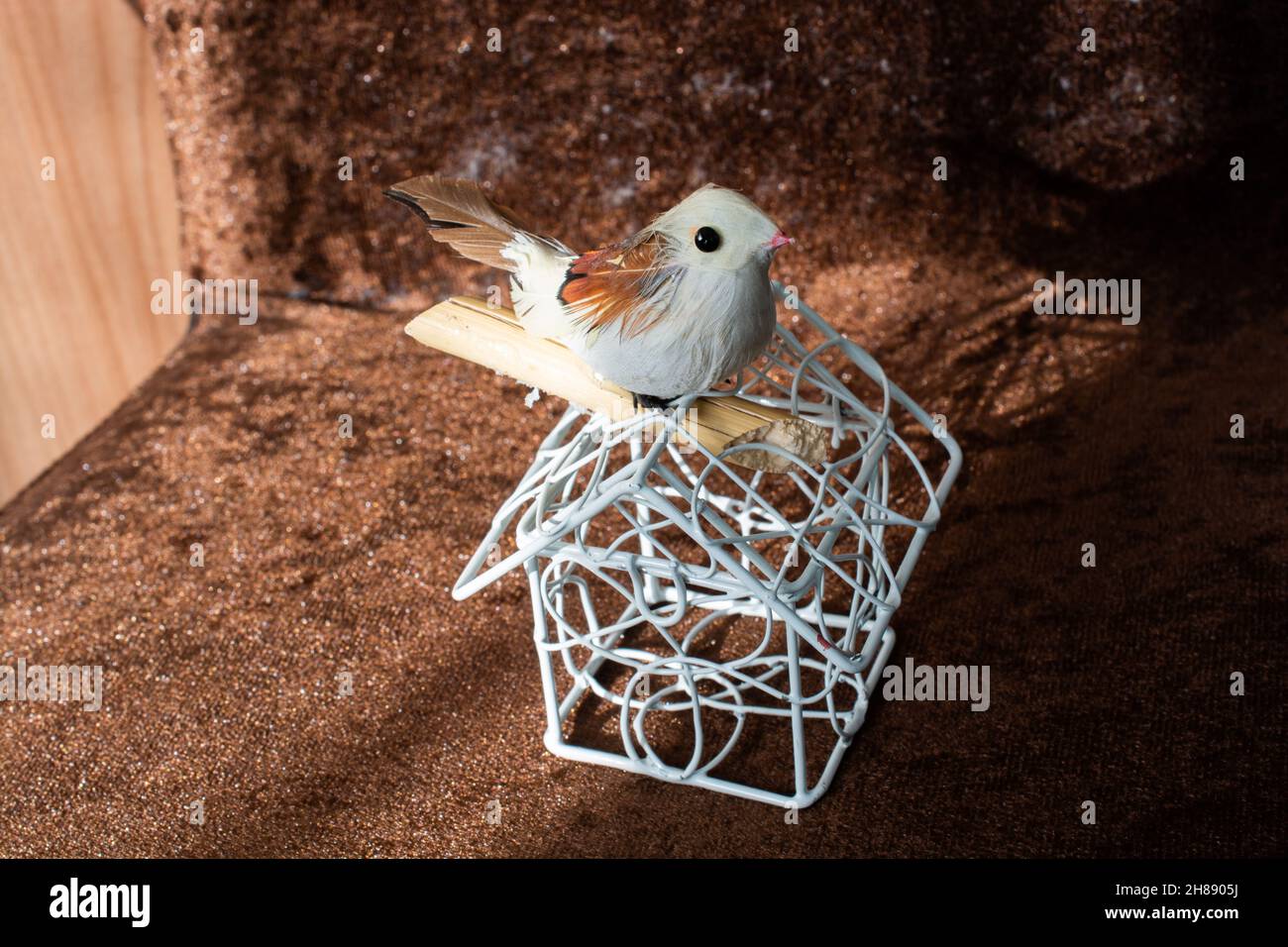 Artificial bird on white metal cage Stock Photo Alamy