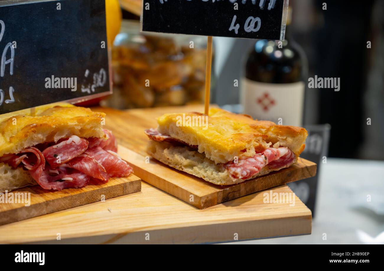 Italian street food, Parma ham sandwiches, bread with cured meats in market in Florence, Italy