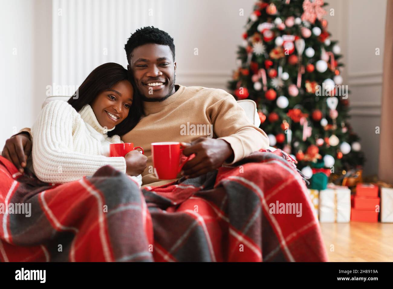 Portrait of happy black family watching tv on Xmas Stock Photo - Alamy