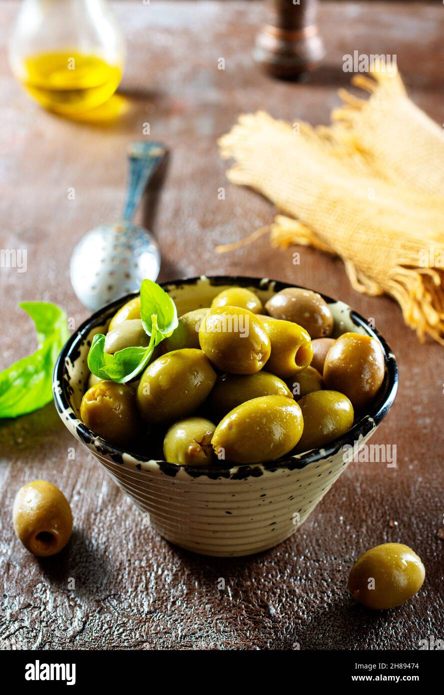green olives in olive oil Stock Photo Alamy
