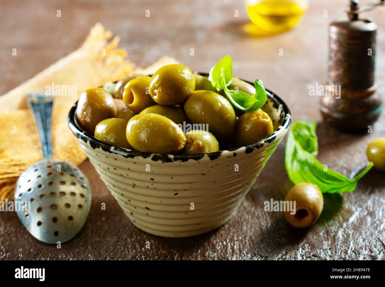 green olives in olive oil Stock Photo - Alamy