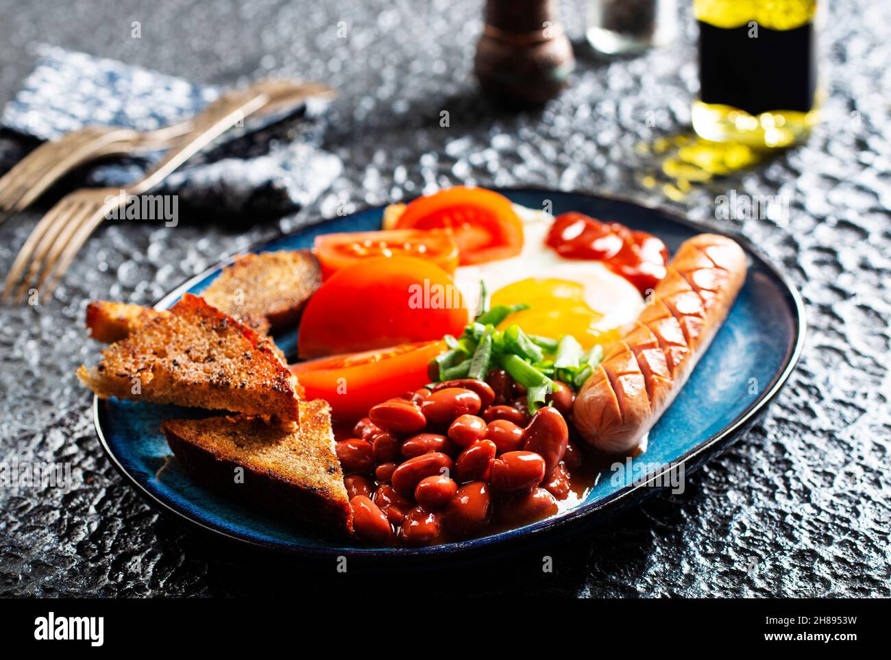 English breakfast with sausage, eggs and beans Stock Photo Alamy