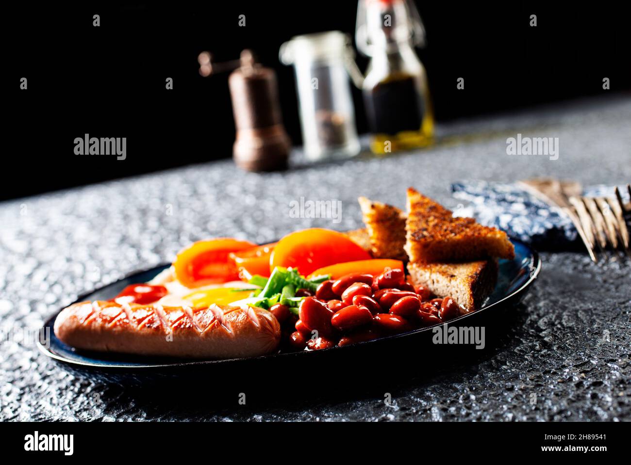 English breakfast with sausage, eggs and beans Stock Photo Alamy