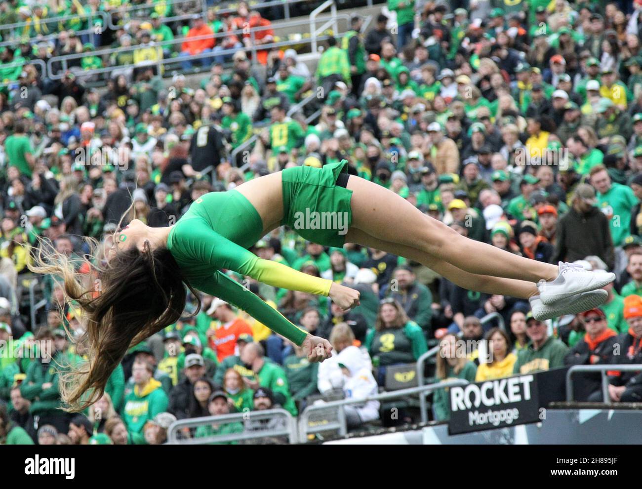 Autzen Stadium, Eugene, OR, USA. 27th Nov, 2021. An Oregon Duck cheerleader flies high during the first half of the NCAA football game between the Oregon State Beavers and the Oregon Ducks at Autzen Stadium, Eugene, OR. Larry C. Lawson/CSM (Cal Sport Media via AP Images). Credit: csm/Alamy Live News Stock Photo