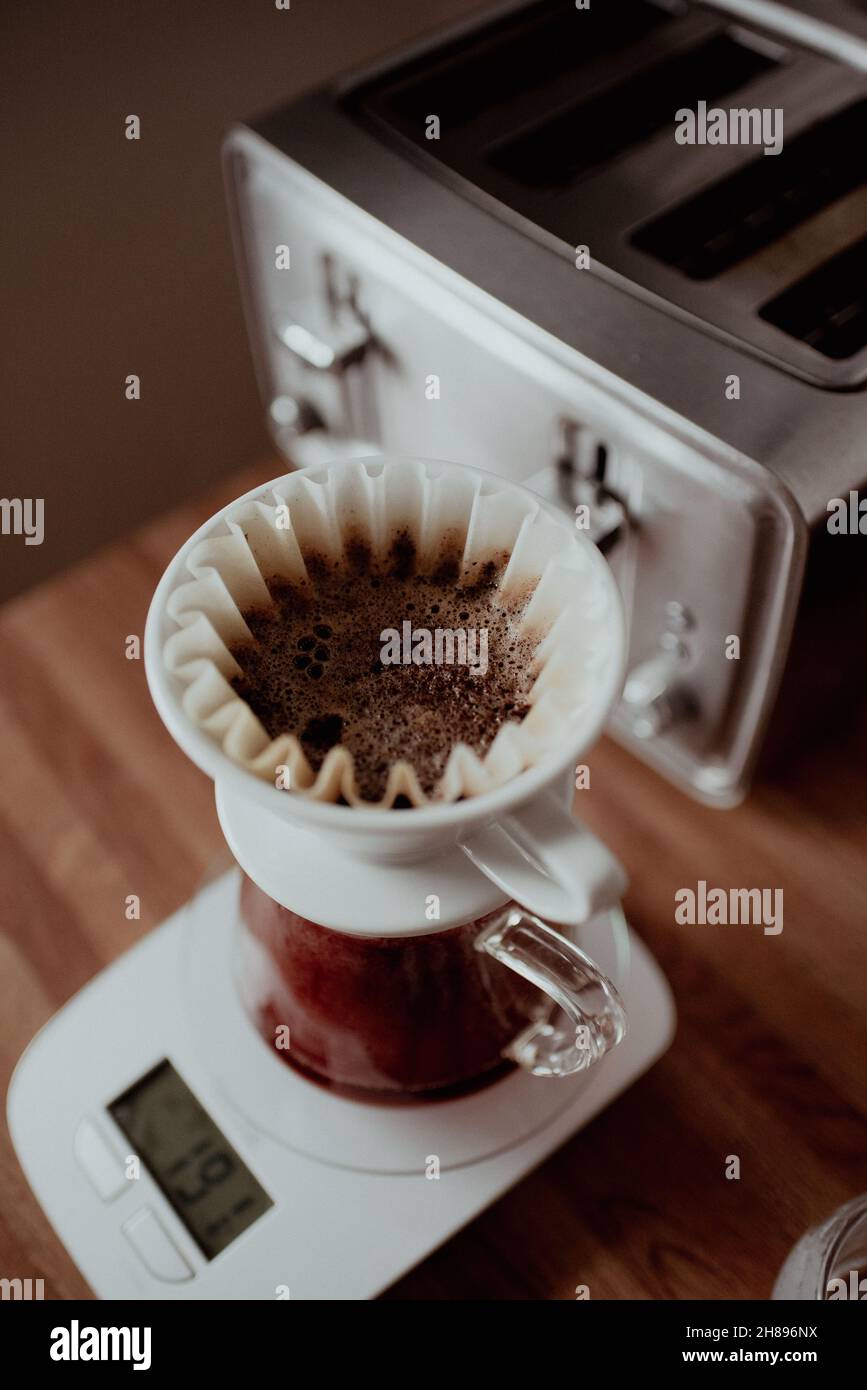 https://c8.alamy.com/comp/2H896NX/pouring-hot-water-from-gooseneck-kettle-into-pour-over-coffee-maker-slow-coffee-extraction-freshly-brewed-filtered-coffee-making-coffee-at-home-2H896NX.jpg