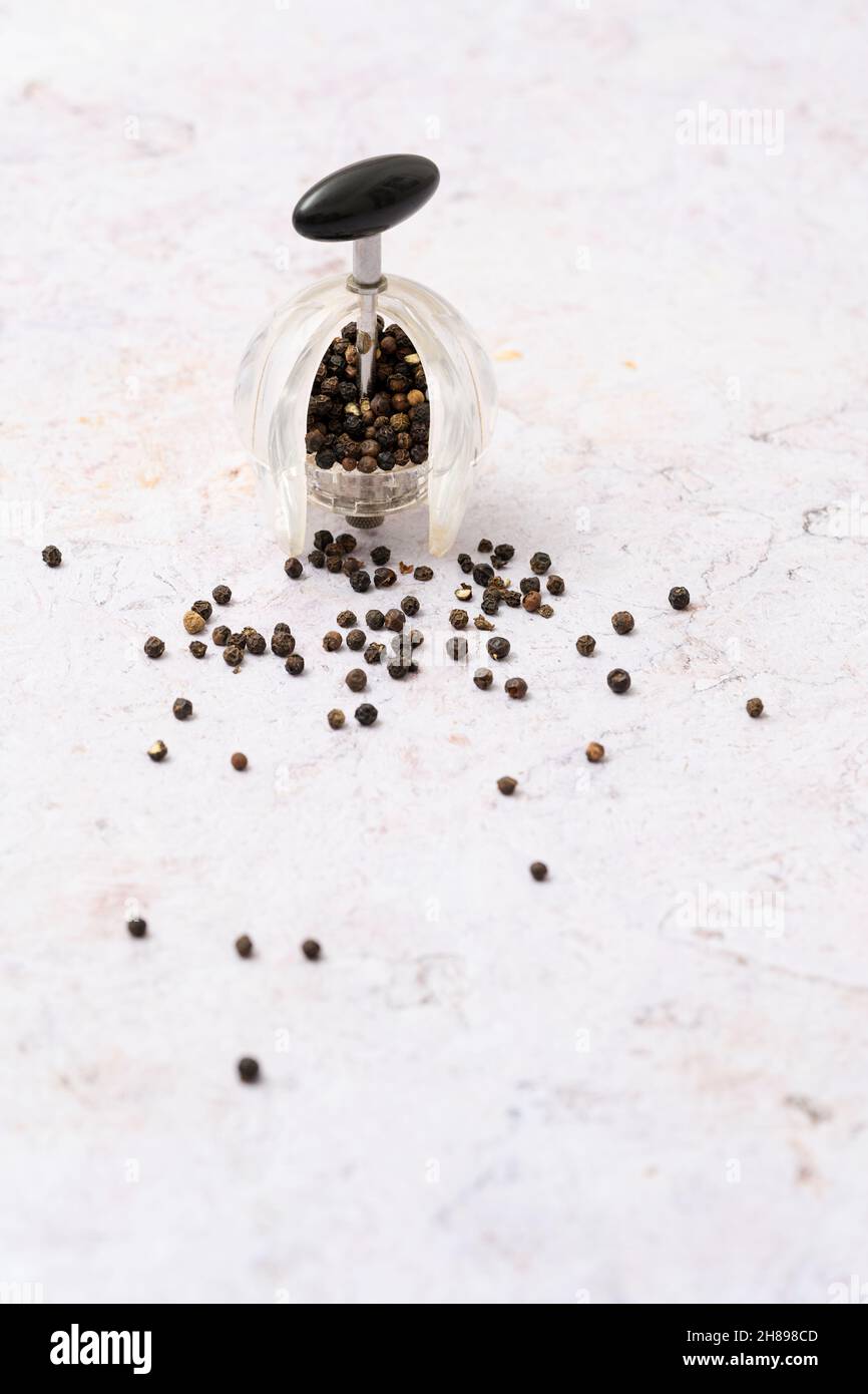 Black pepper mill and peppercorns Stock Photo Alamy