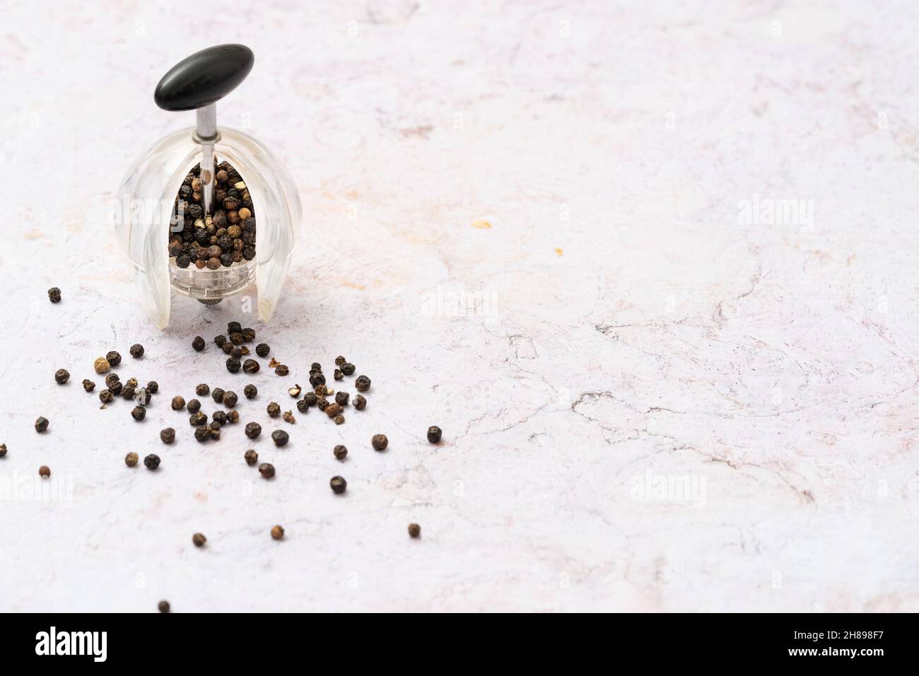 Black pepper mill and peppercorns Stock Photo Alamy