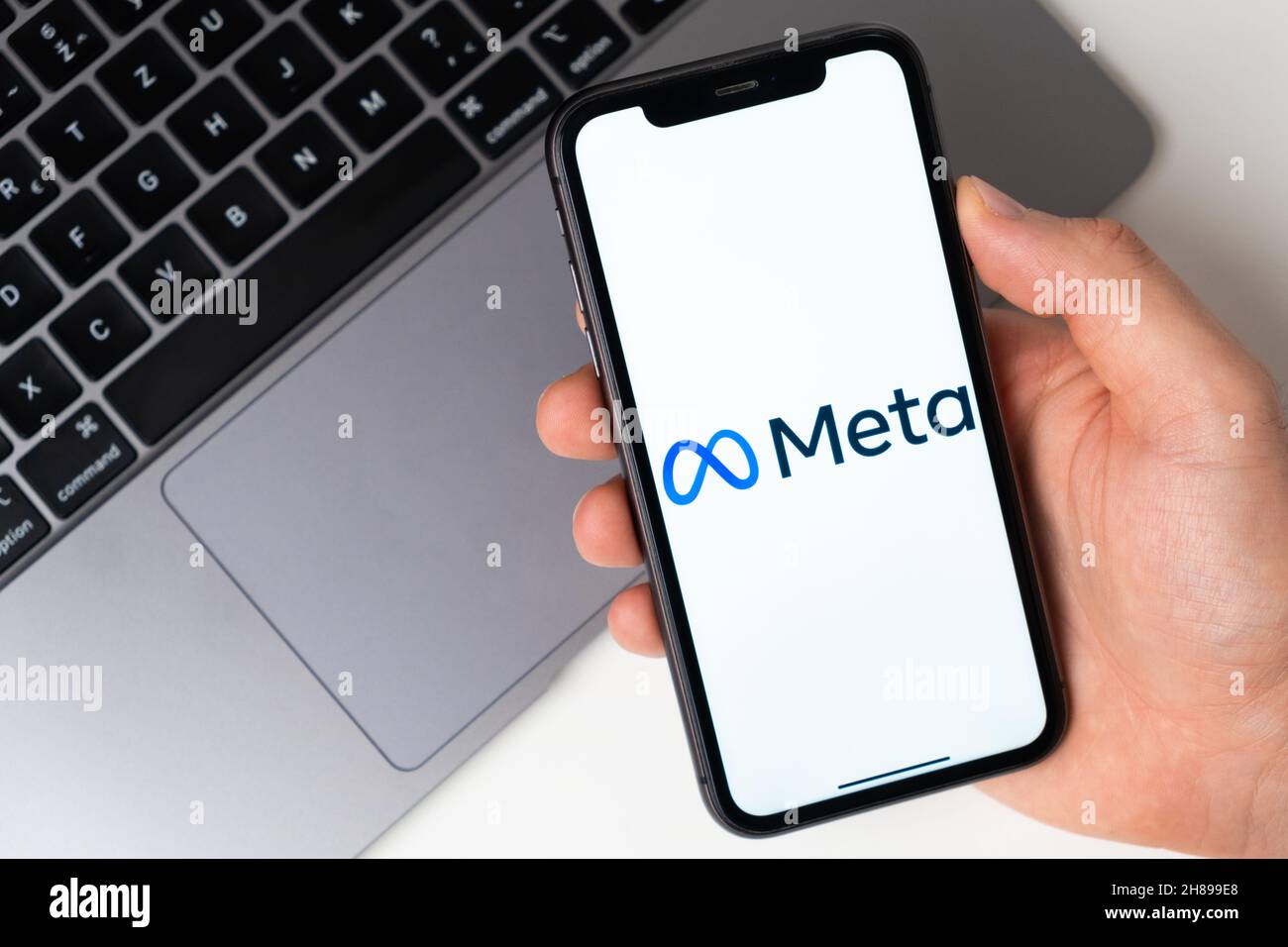 Meta the application is open in the smartphone. The man is holding a mobile phone in his hand, the company application is open on the screen. Secure online shopping. November 2021, San Francisco, USA Stock Photo