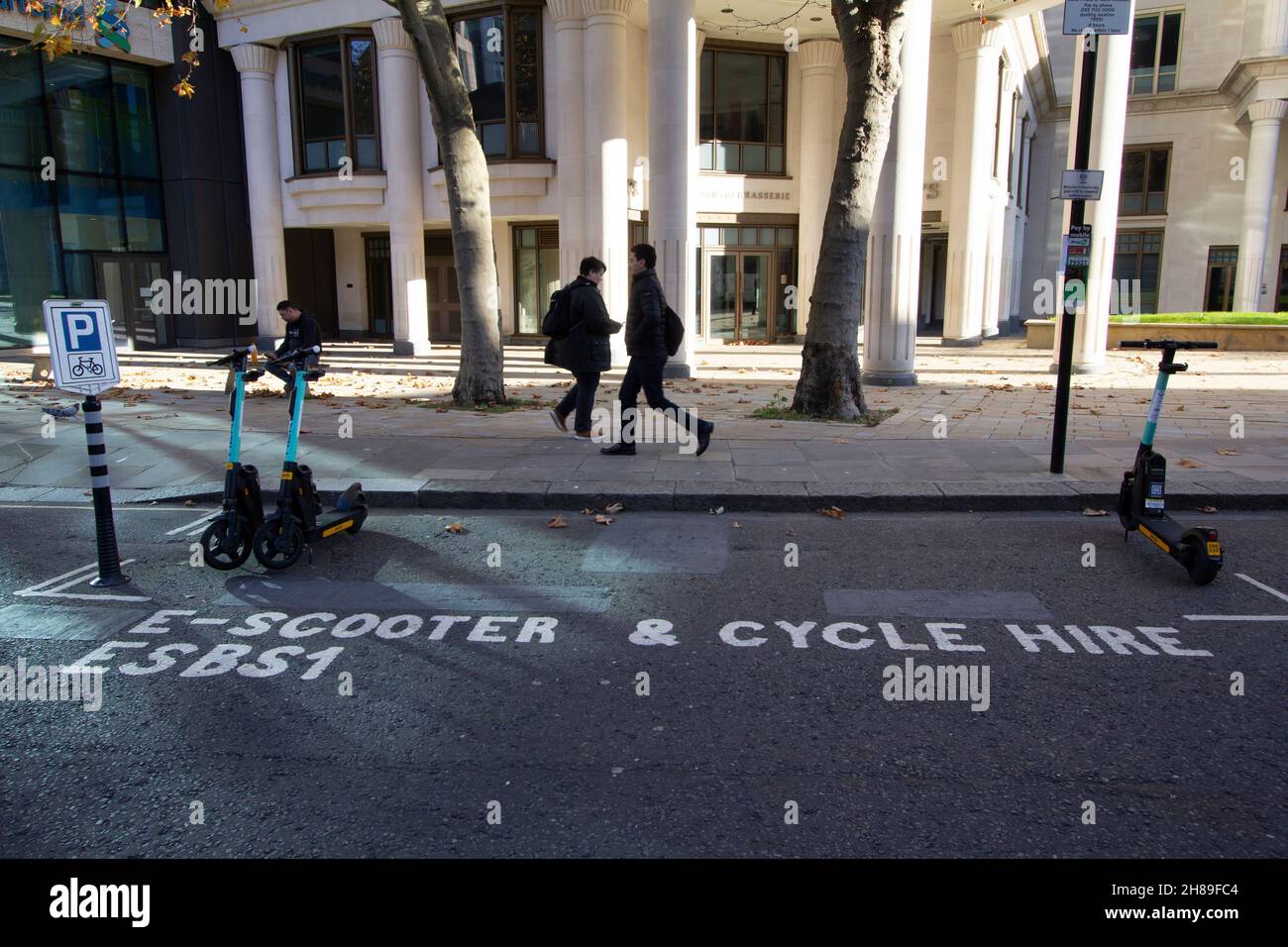two lone Tier electric scooters in partially empty Scooter and cycle