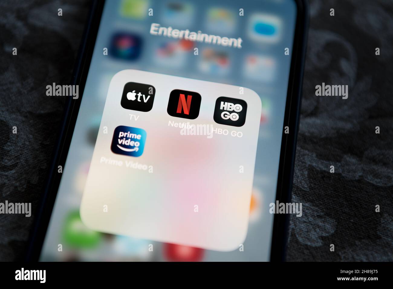 Krakow, Poland - July 14, 2021: Netflix application icon among Apple TV+, Amazon Prime Video, and HBO GO in Entertainment Folder on Apple iPhone 12 Pr Stock Photo