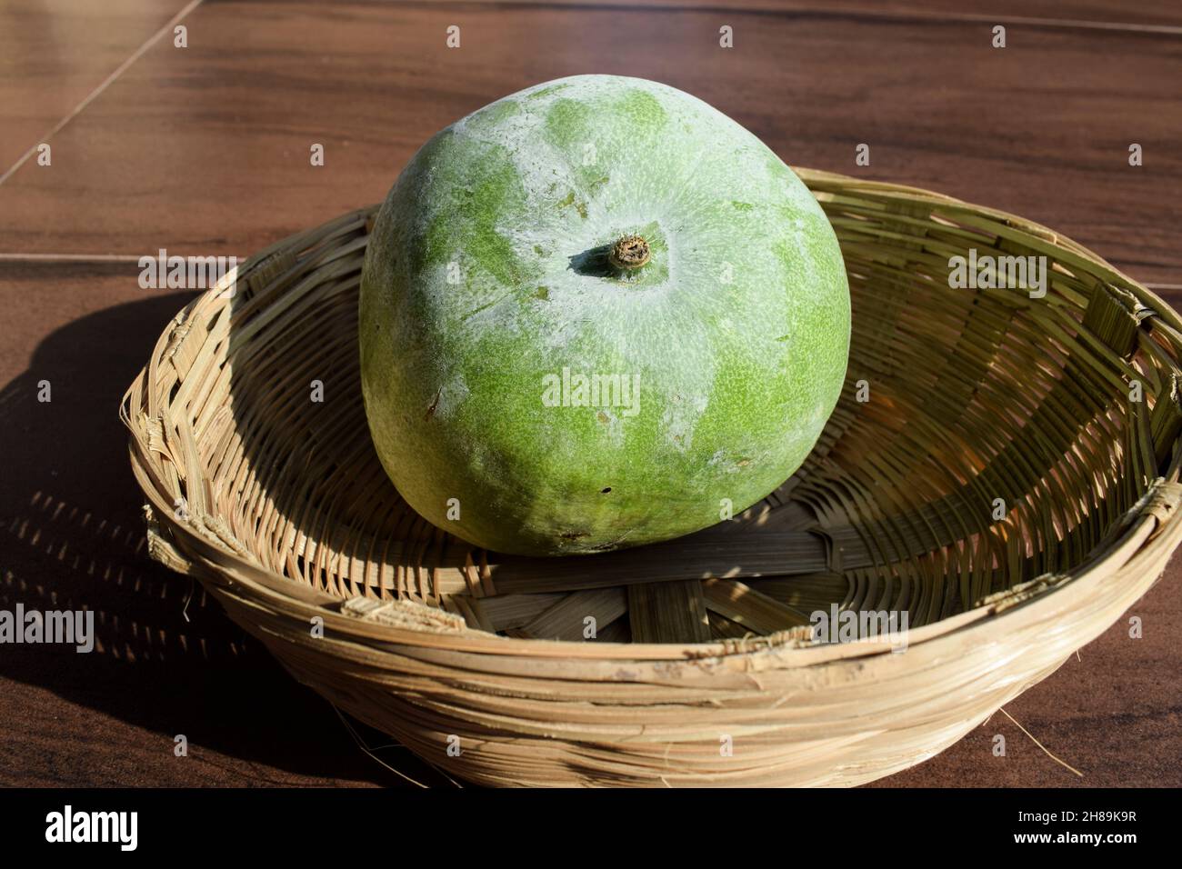 Fresh Indian vegetable called Ash gourd in wicker basket. Indian vegetable in wicker basket Stock Photo