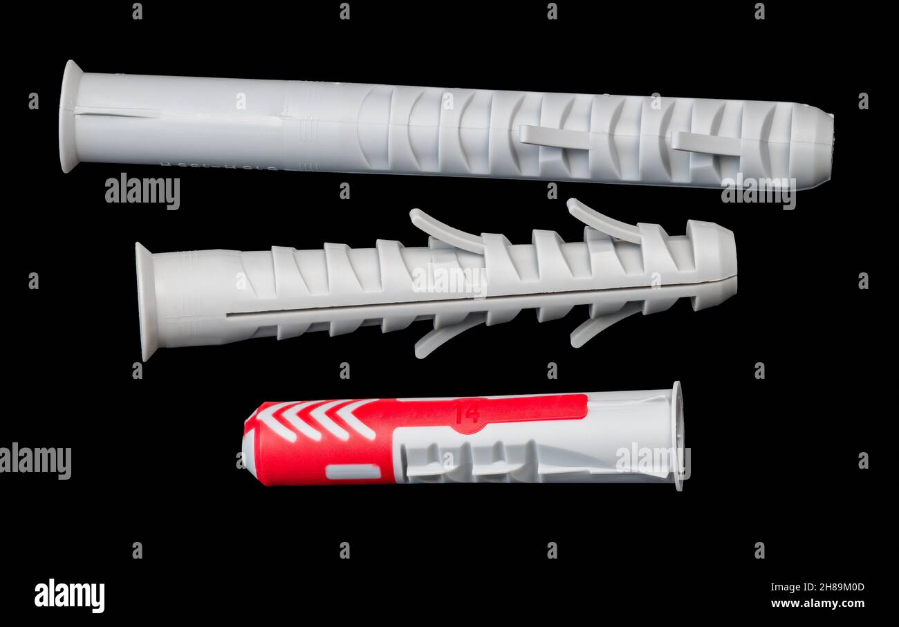 Set of different plastic wall plugs isolated on black background