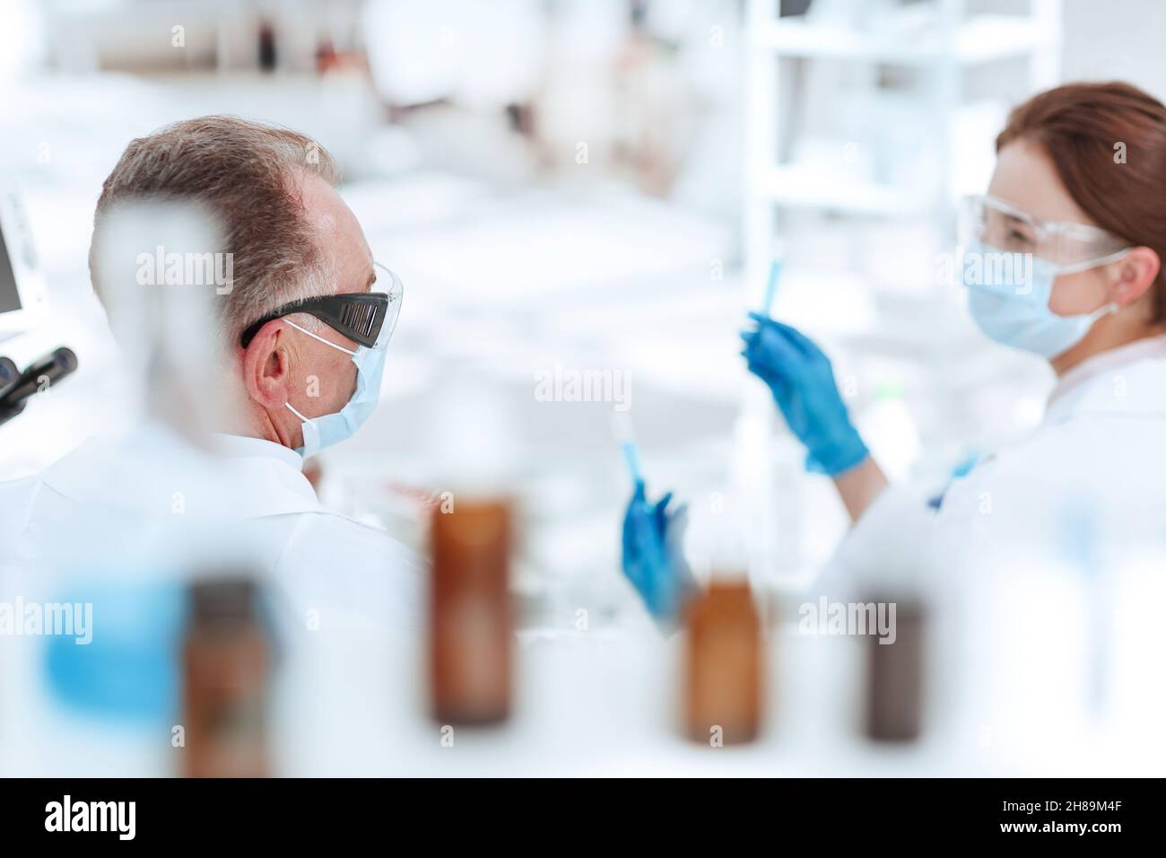 rear view . medical colleagues discussing the results of the experiment. Stock Photo