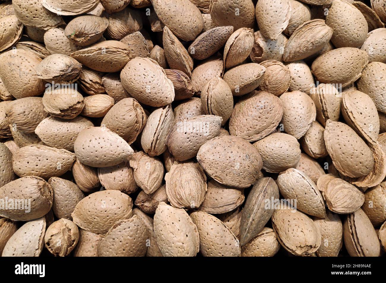 Closeup on a stack of almonds for sale on a market stall Stock Photo