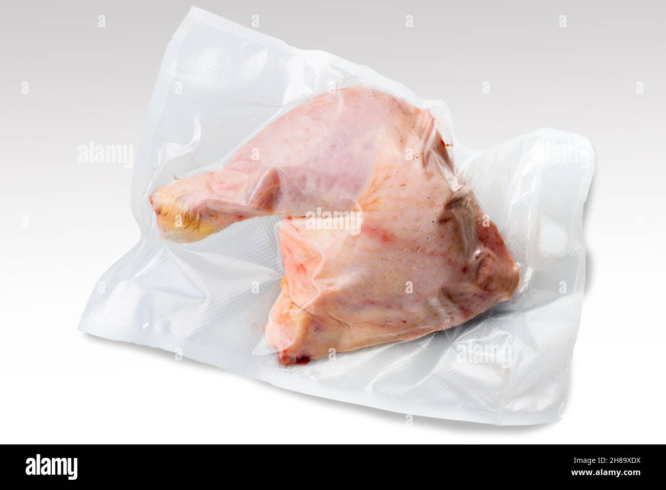 Whole chicken thighs in vacuum packed sealed for sous vide cooking isolated on white background Stock Photo