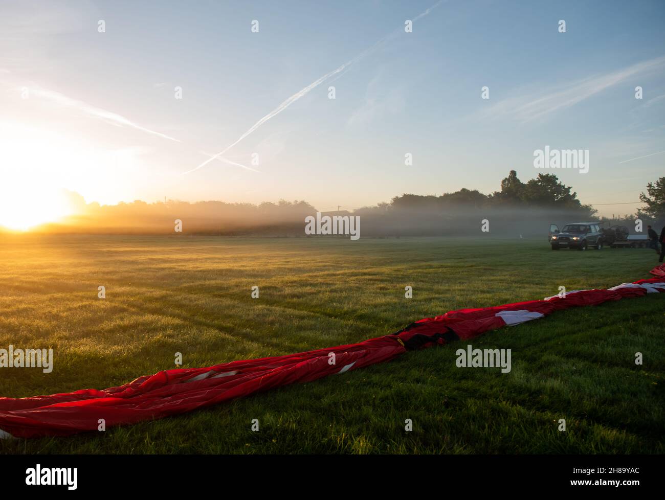Getting ready to fly a hot air balloon early in the morning Stock Photo